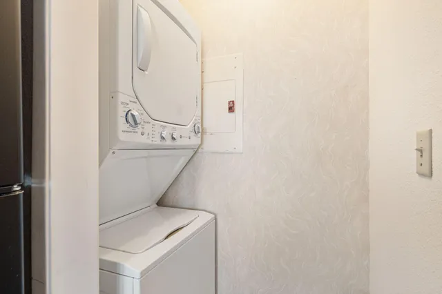 a view of a dining room with furniture and a chandelier