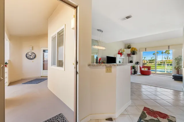 a view of living room filled with furniture and a window