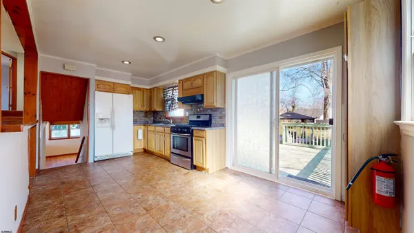 a kitchen with stainless steel appliances a refrigerator and a stove top oven