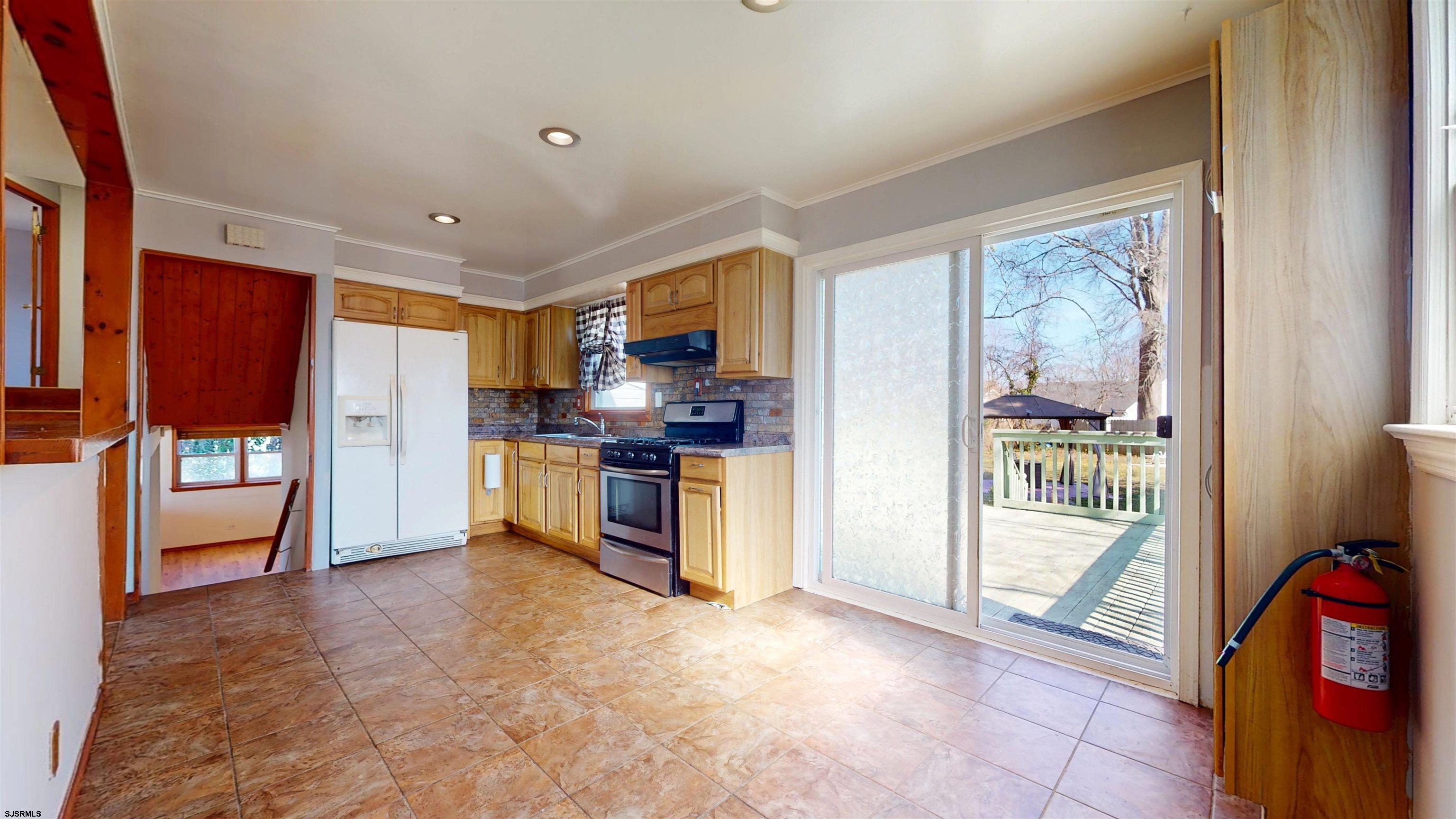 123 Devon Road Somers Point, NJ 08244 - Photo 12 of 41 a kitchen with stainless steel appliances a refrigerator and a stove top oven
