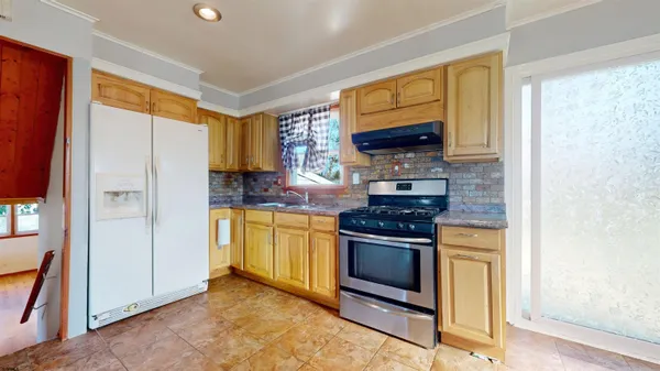 a kitchen with stainless steel appliances granite countertop a stove microwave and refrigerator