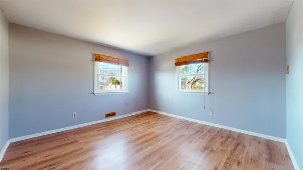 a view of room with window and wooden floor