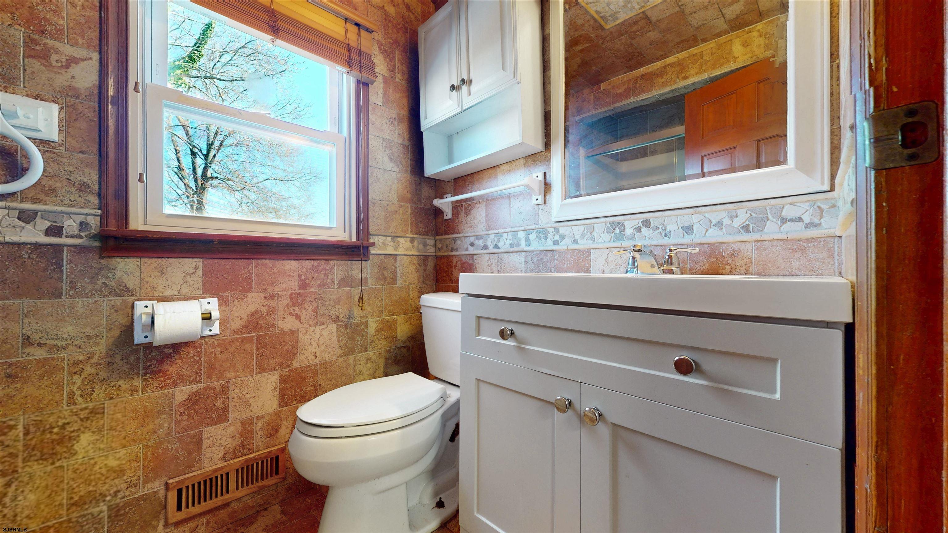 123 Devon Road Somers Point, NJ 08244 - Photo 20 of 41 a bathroom with a toilet sink and mirror