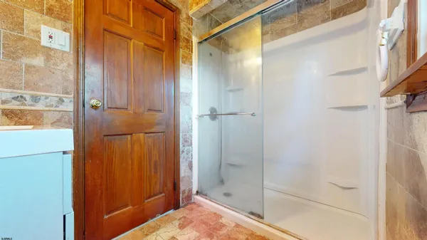 a bathroom with a shower and a sink