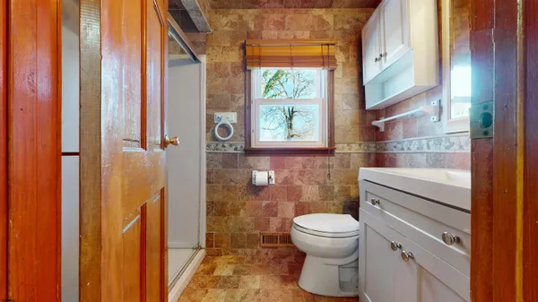 a bathroom with a toilet and a shower