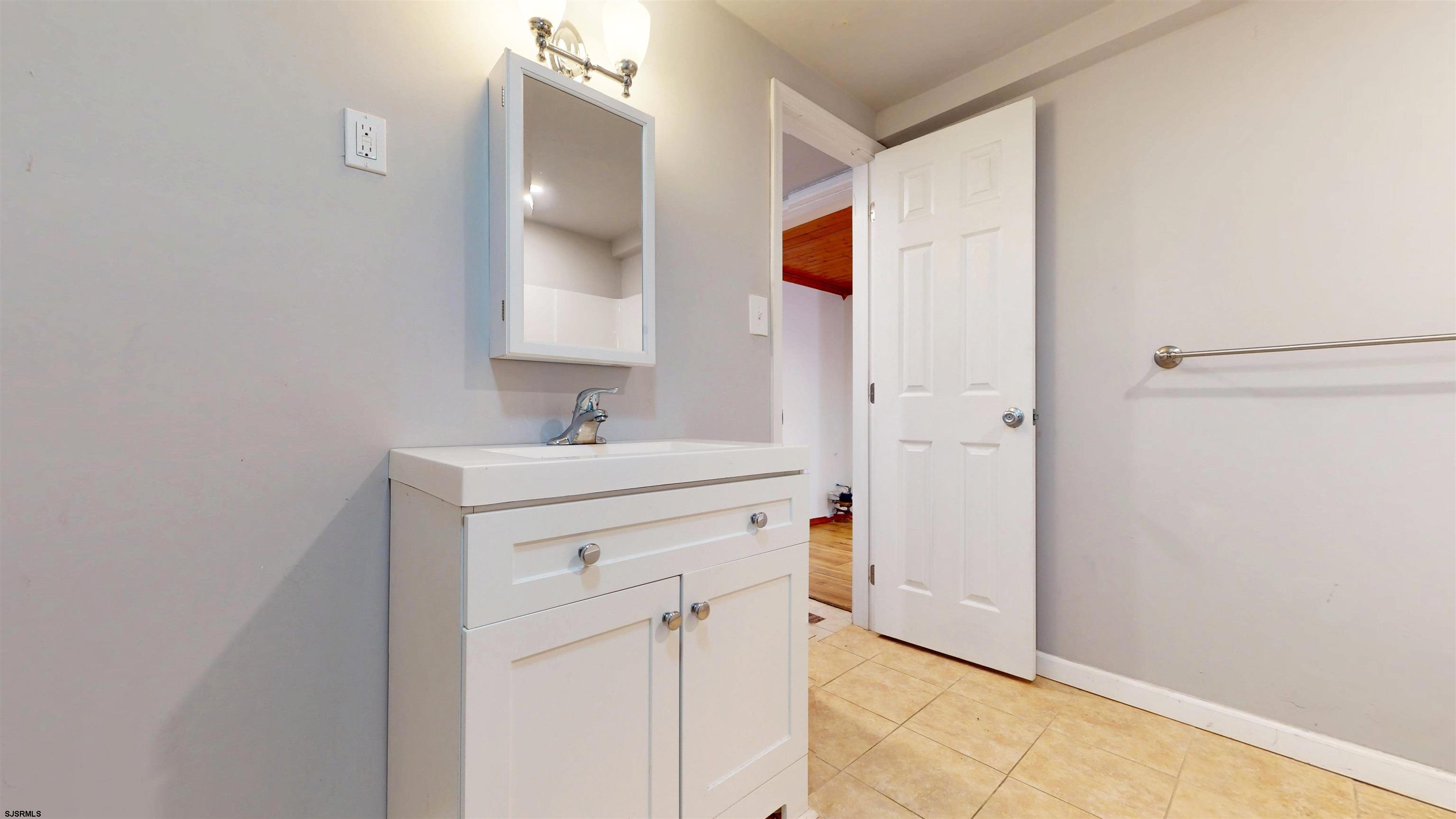 123 Devon Road Somers Point, NJ 08244 - Photo 27 of 41 a bathroom with a sink and a mirror