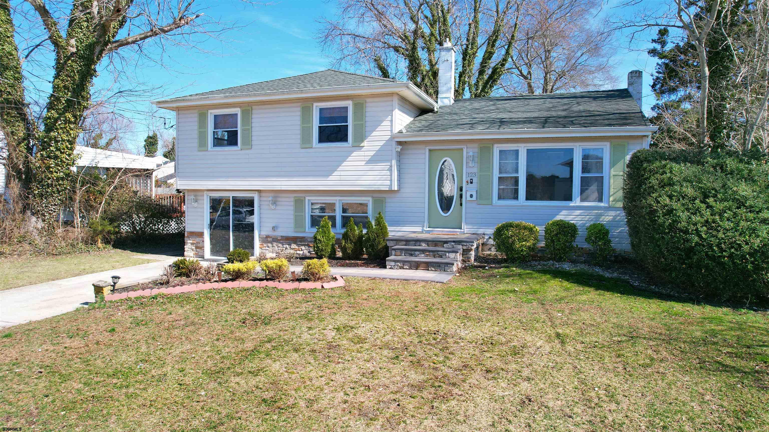 123 Devon Road Somers Point, NJ 08244 - Photo 4 of 41 a front view of a house with garden and porch