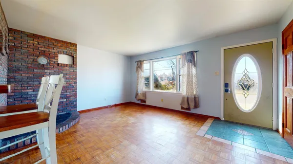 an empty room with windows lake view and wooden floor