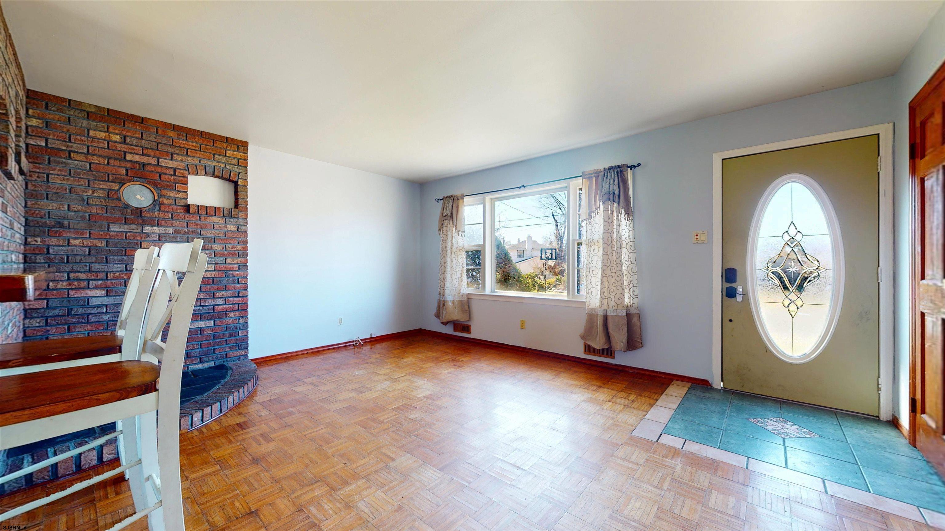 123 Devon Road Somers Point, NJ 08244 - Photo 5 of 41 an empty room with windows lake view and wooden floor