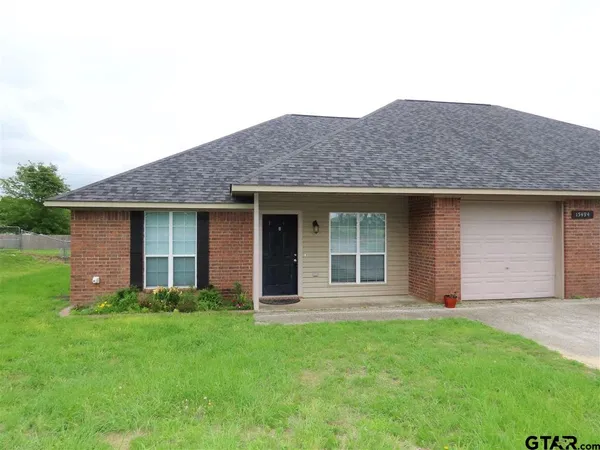 a brick house with a yard