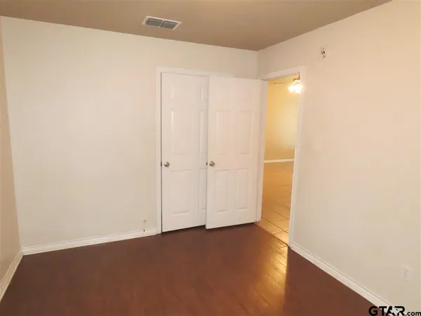 an empty room with wooden floor