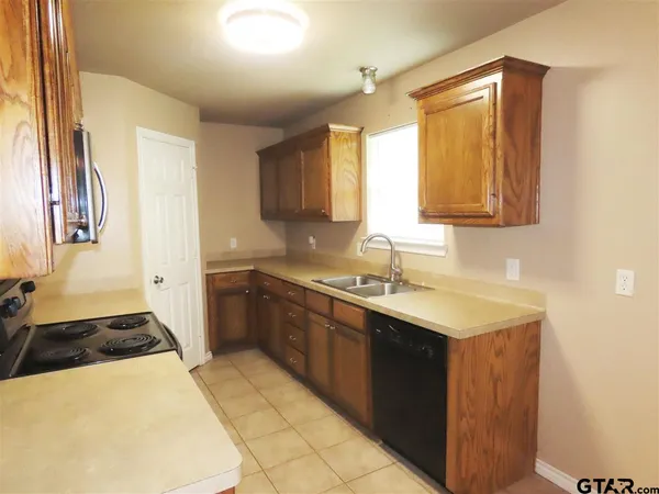 a kitchen with a sink stove and cabinets