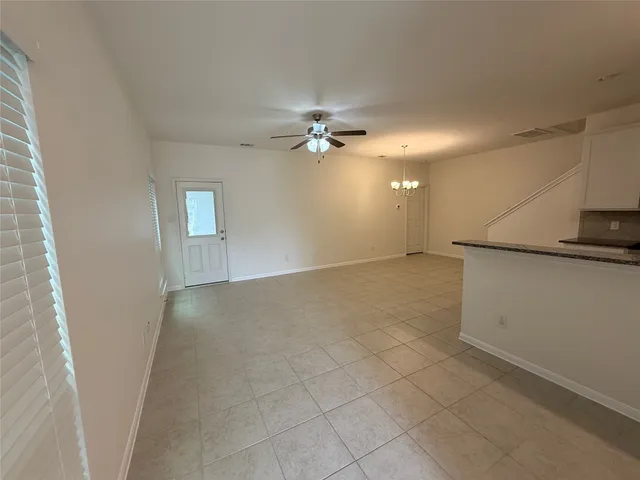 a view of a kitchen with a sink and a chandelier