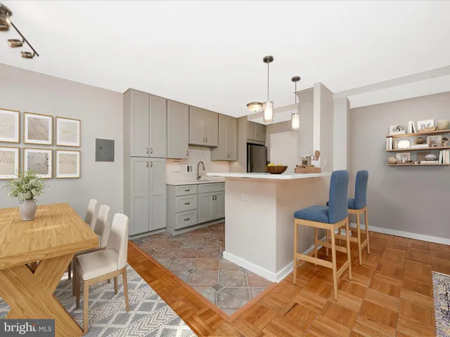 a living room with stainless steel appliances kitchen island granite countertop furniture and a rug