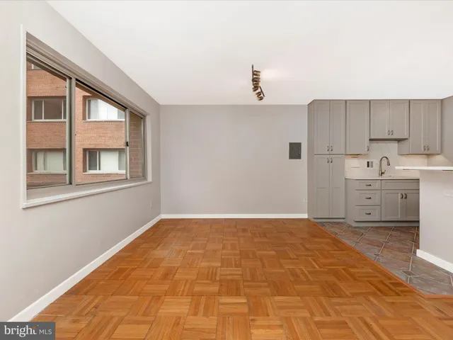 a view of a kitchen with a sink and cabinet with wooden floor
