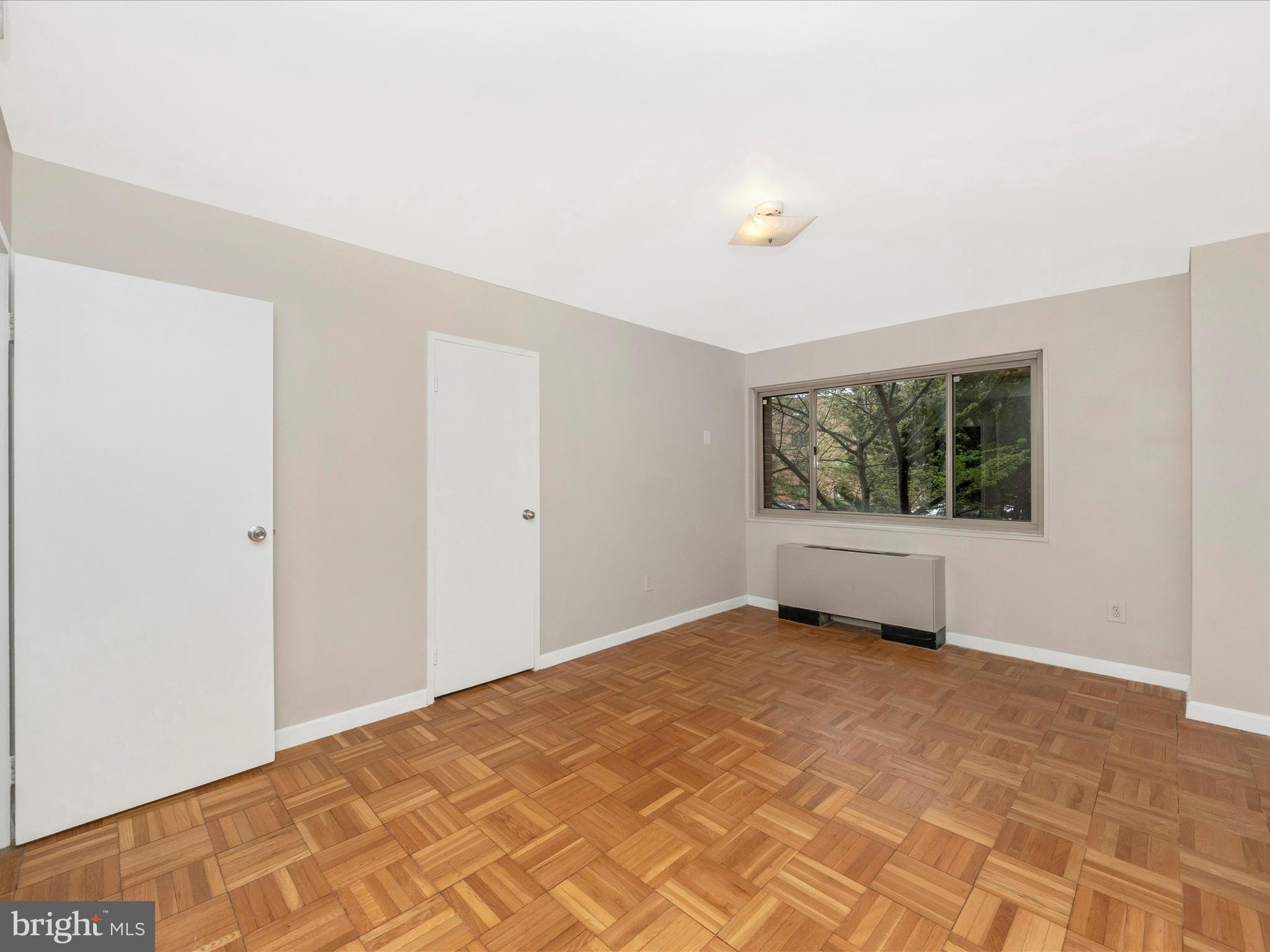 3900 Tunlaw Road Northwest, Unit 104 Washington, DC 20007 - Photo 15 of 36 a view of an empty room with a window