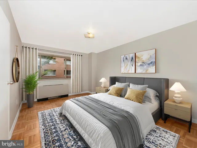 a bedroom with a bed a couch and a window