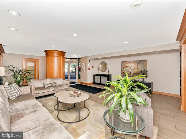 a living room with furniture and white wooden floor