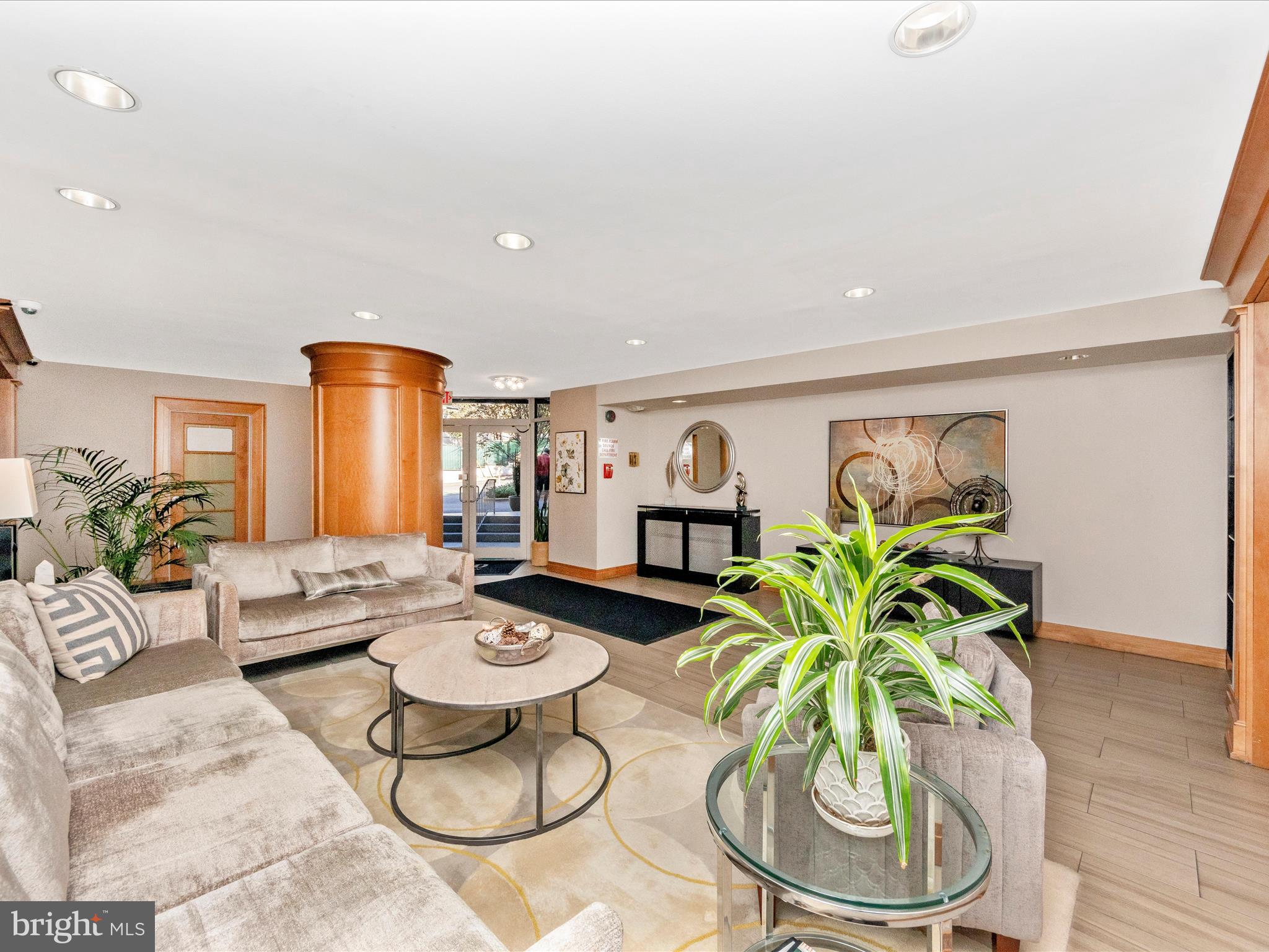 3900 Tunlaw Road Northwest, Unit 104 Washington, DC 20007 - Photo 27 of 36 a living room with furniture and white wooden floor