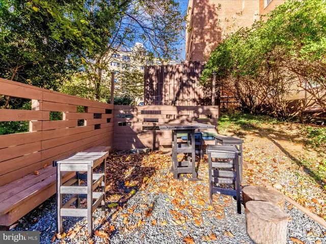 a view of a chairs and table in backyard