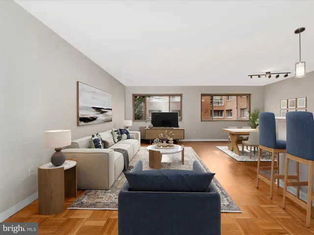 a living room with furniture wooden floor and a flat screen tv