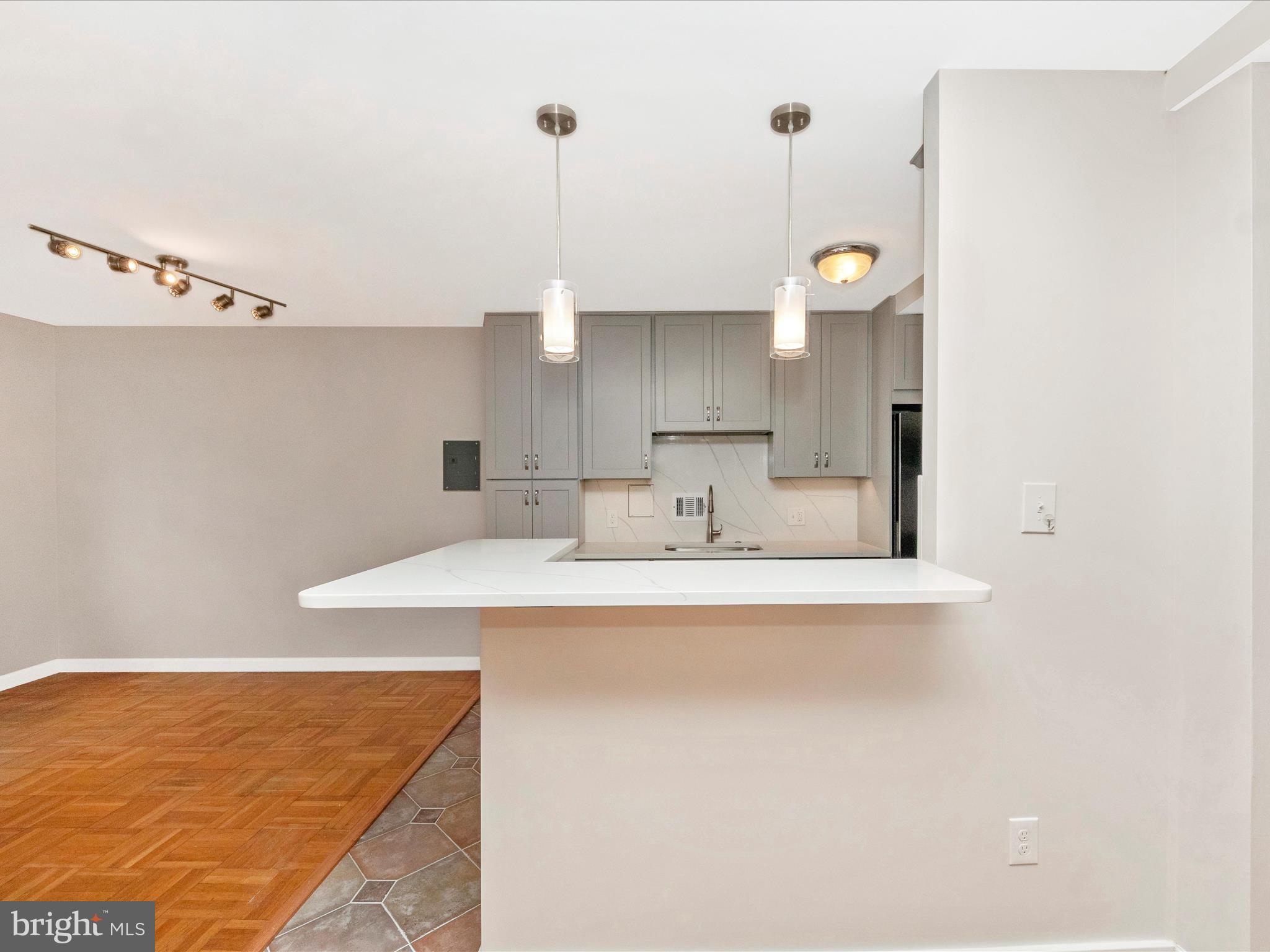 3900 Tunlaw Road Northwest, Unit 104 Washington, DC 20007 - Photo 8 of 36 a kitchen with a sink cabinets and wooden floor