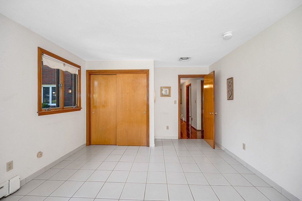 9 Seneca Drive Danvers, MA 01923 - Photo 27 of 41 a view of an empty room with window and chandelier fan