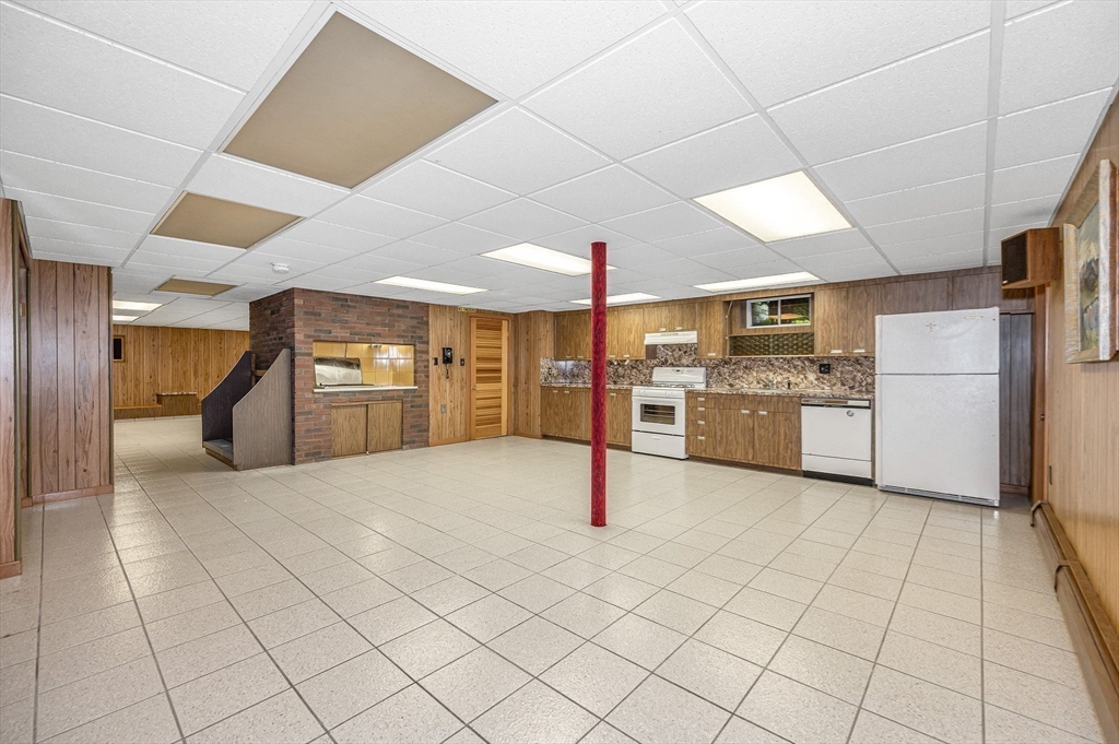 9 Seneca Drive Danvers, MA 01923 - Photo 32 of 41 a large white kitchen with a refrigerator and cabinets