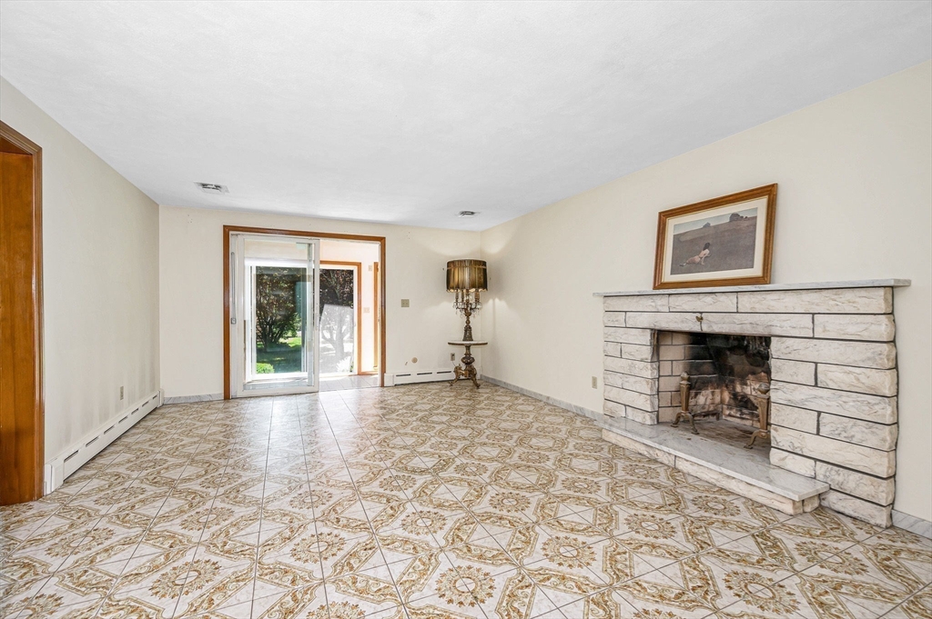 9 Seneca Drive Danvers, MA 01923 - Photo 9 of 41 a view of a livingroom with a fireplace and window