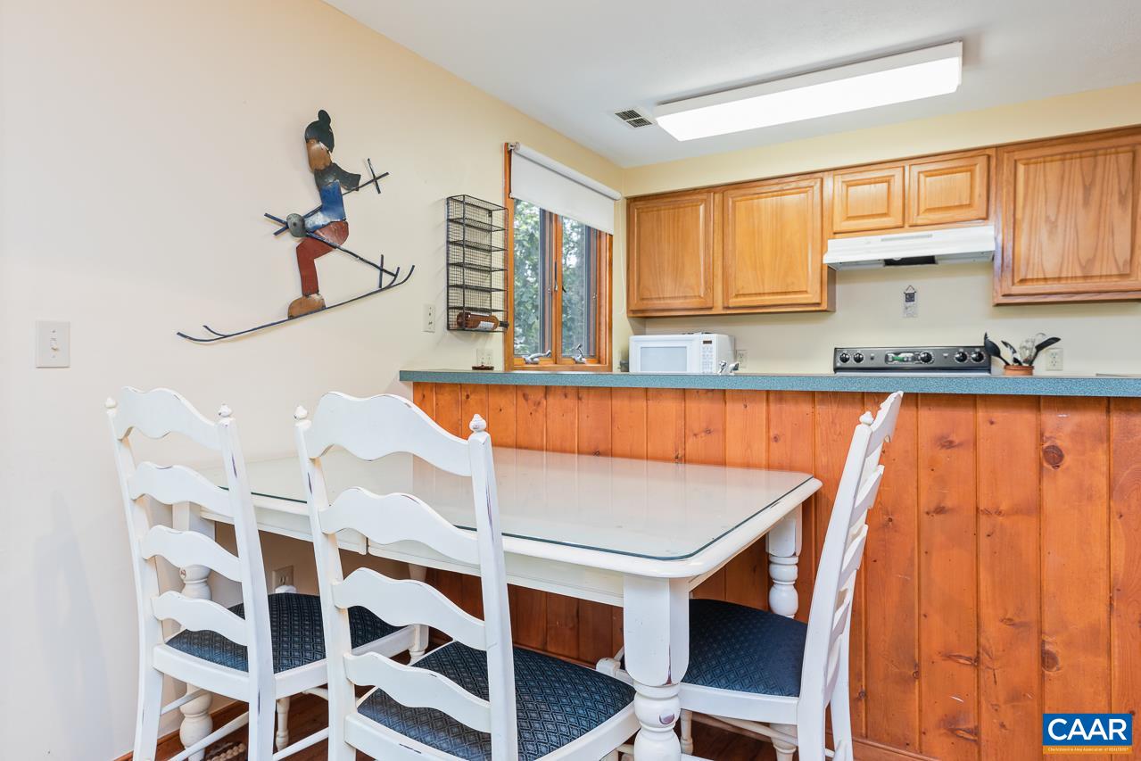 402 3 Ridges Roseland, VA 22967 - Photo 7 of 15 a kitchen with a sink a window and cabinets