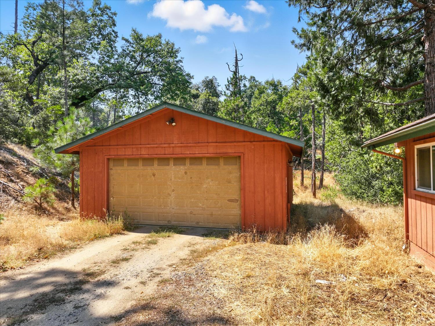 39712 Deer Ridge Drive Oakhurst, CA 93644 - Photo 33 of 40 a front view of a house with a yard covered in snow