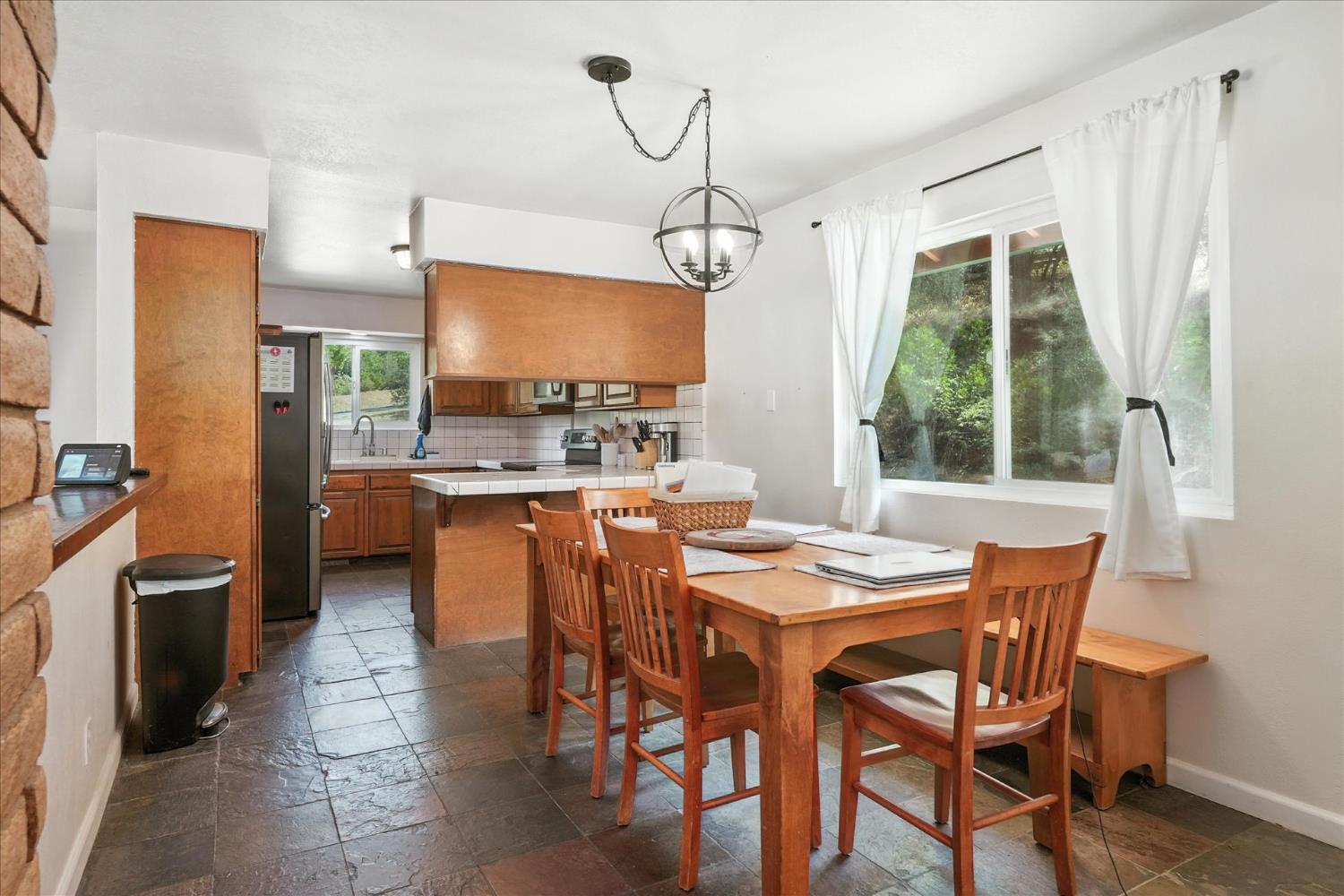 39712 Deer Ridge Drive Oakhurst, CA 93644 - Photo 5 of 40 a dining room with stainless steel appliances a table and chairs