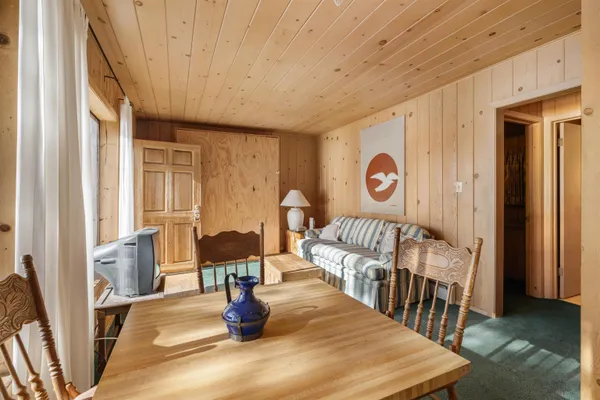 a living room with furniture wooden floor and a table