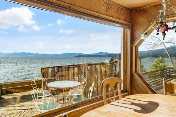 a view of a balcony with a table and chairs