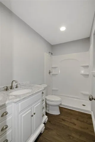 a bathroom with a double vanity sink toilet and shower