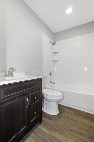 a bathroom with a toilet a sink and bathtub