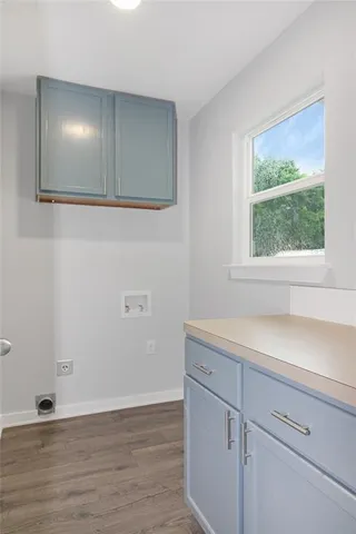 a view of empty room with window and wooden floor