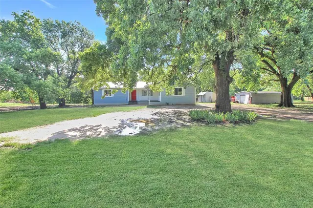 a small house with a bench in front of it