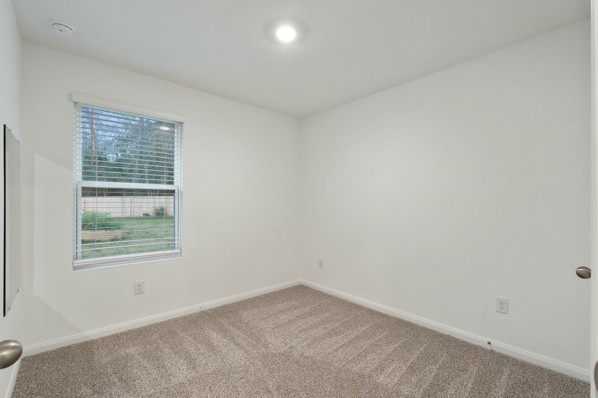 12070 William Trails Circle Willis, TX 77378 - Photo 12 of 18 an empty room with a window