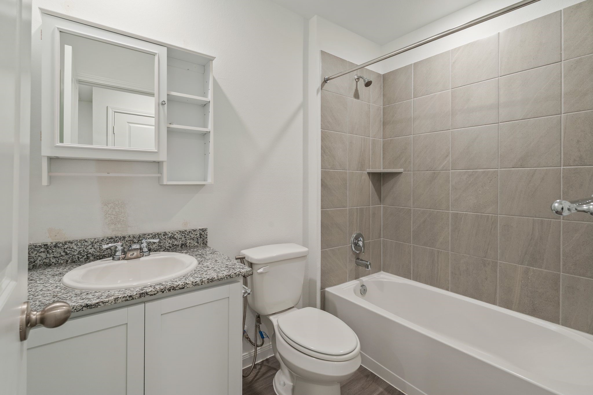 12070 William Trails Circle Willis, TX 77378 - Photo 13 of 18 a bathroom with a granite countertop sink toilet and shower