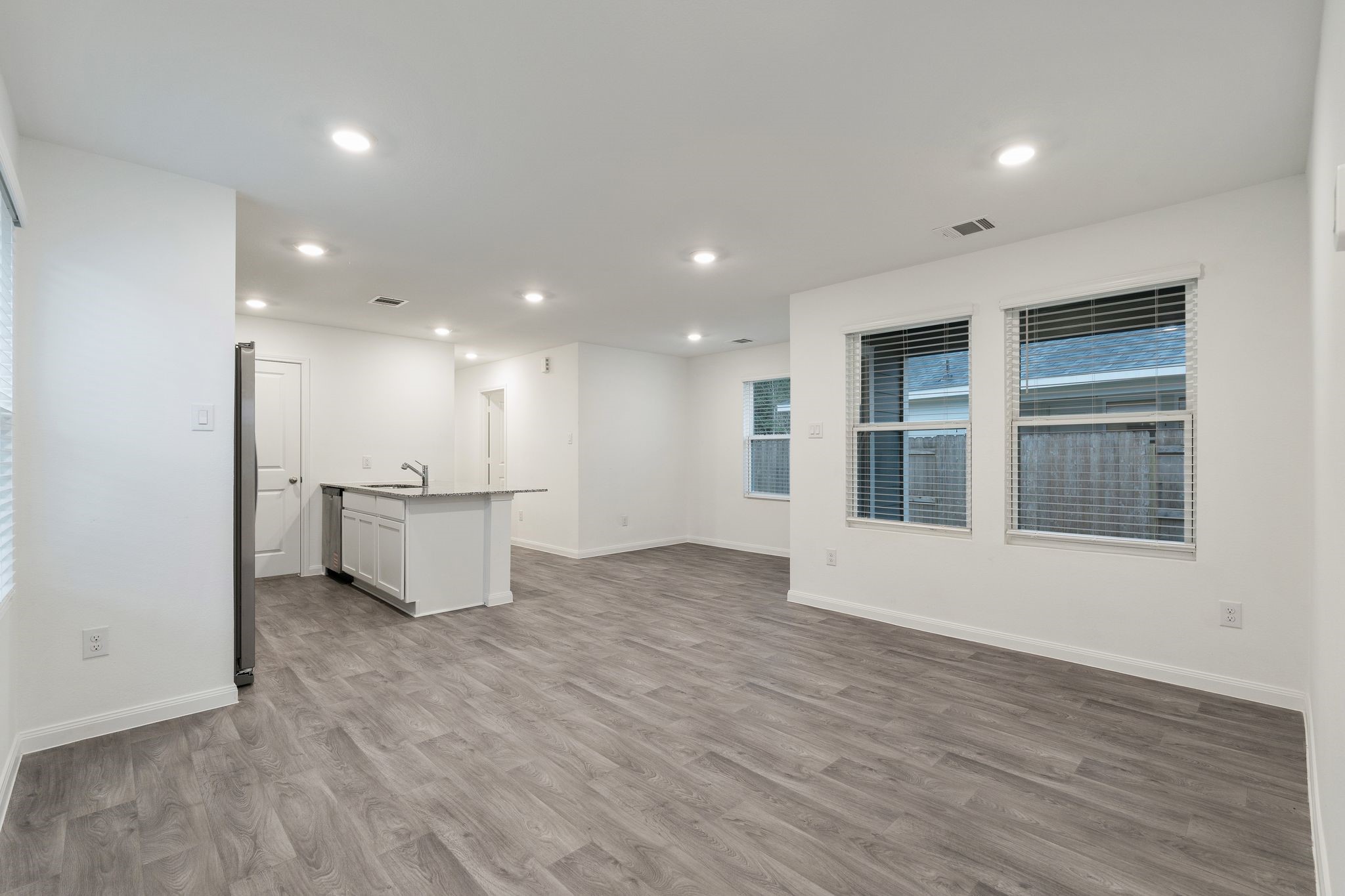 12070 William Trails Circle Willis, TX 77378 - Photo 3 of 18 a view of an empty room with wooden floor and a window