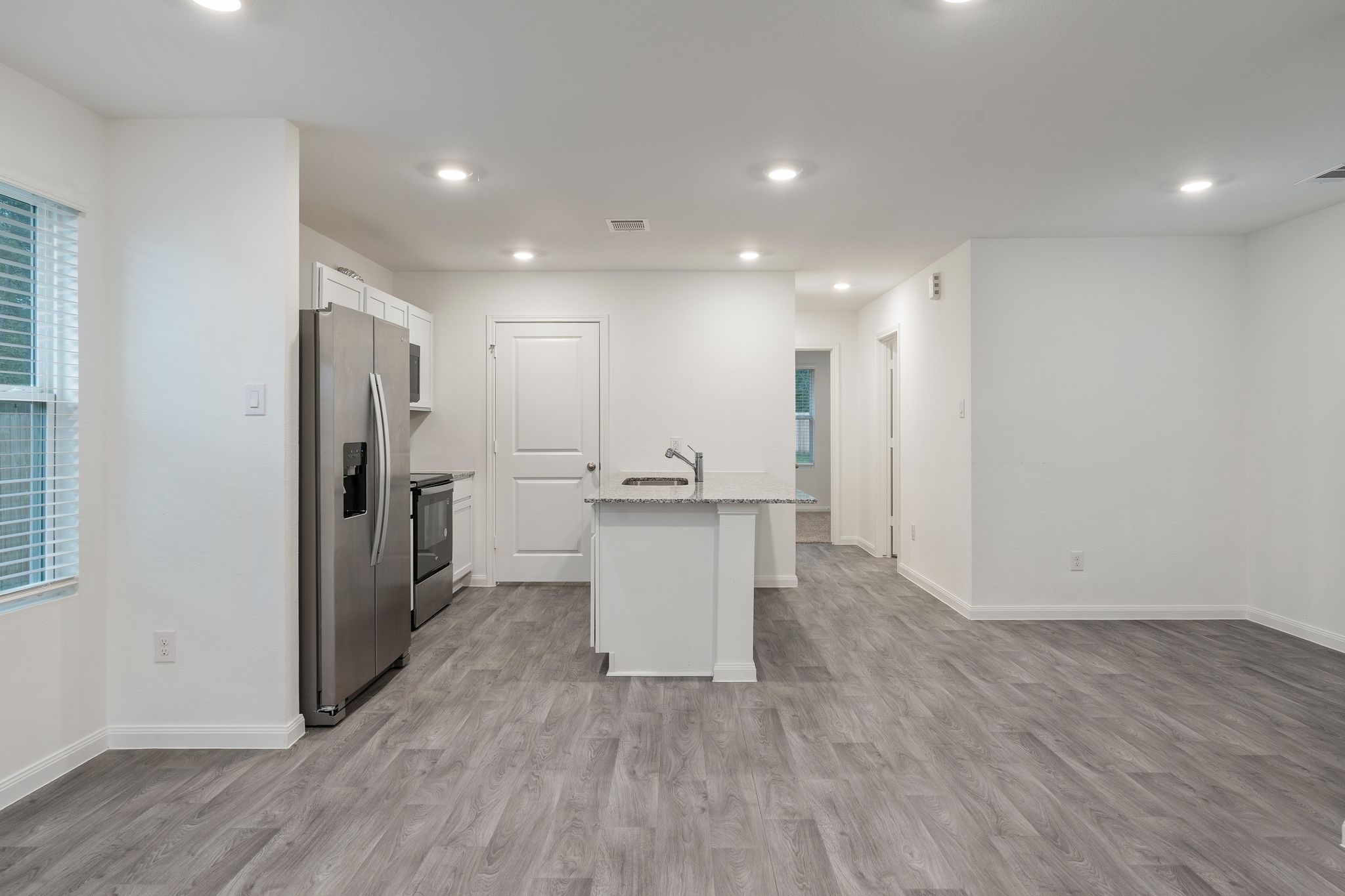 12070 William Trails Circle Willis, TX 77378 - Photo 4 of 18 a view of a kitchen with a refrigerator and a sink