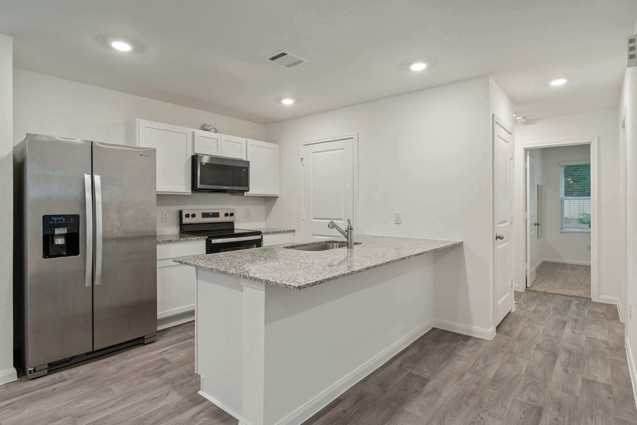 12070 William Trails Circle Willis, TX 77378 - Photo 5 of 18 a kitchen with a refrigerator and a sink