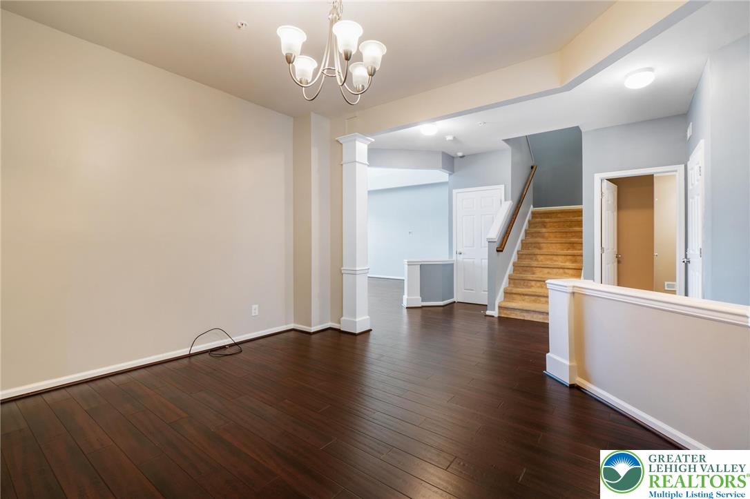 8455 Starling Road Breinigsville, PA 18031 - Photo 5 of 24 Rich hardwood floors welcome you into this inviting interior, framed by elegant columns and a grand staircase.