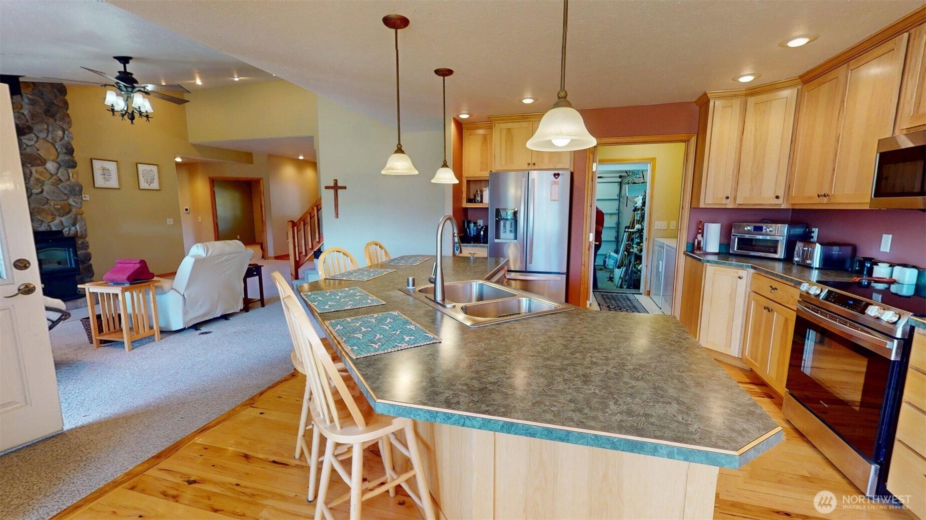 37 No. Name Road Tonasket, WA 98855 - Photo 7 of 33 a large kitchen with stainless steel appliances granite countertop a stove a sink a refrigerator and a dining table with wooden floor
