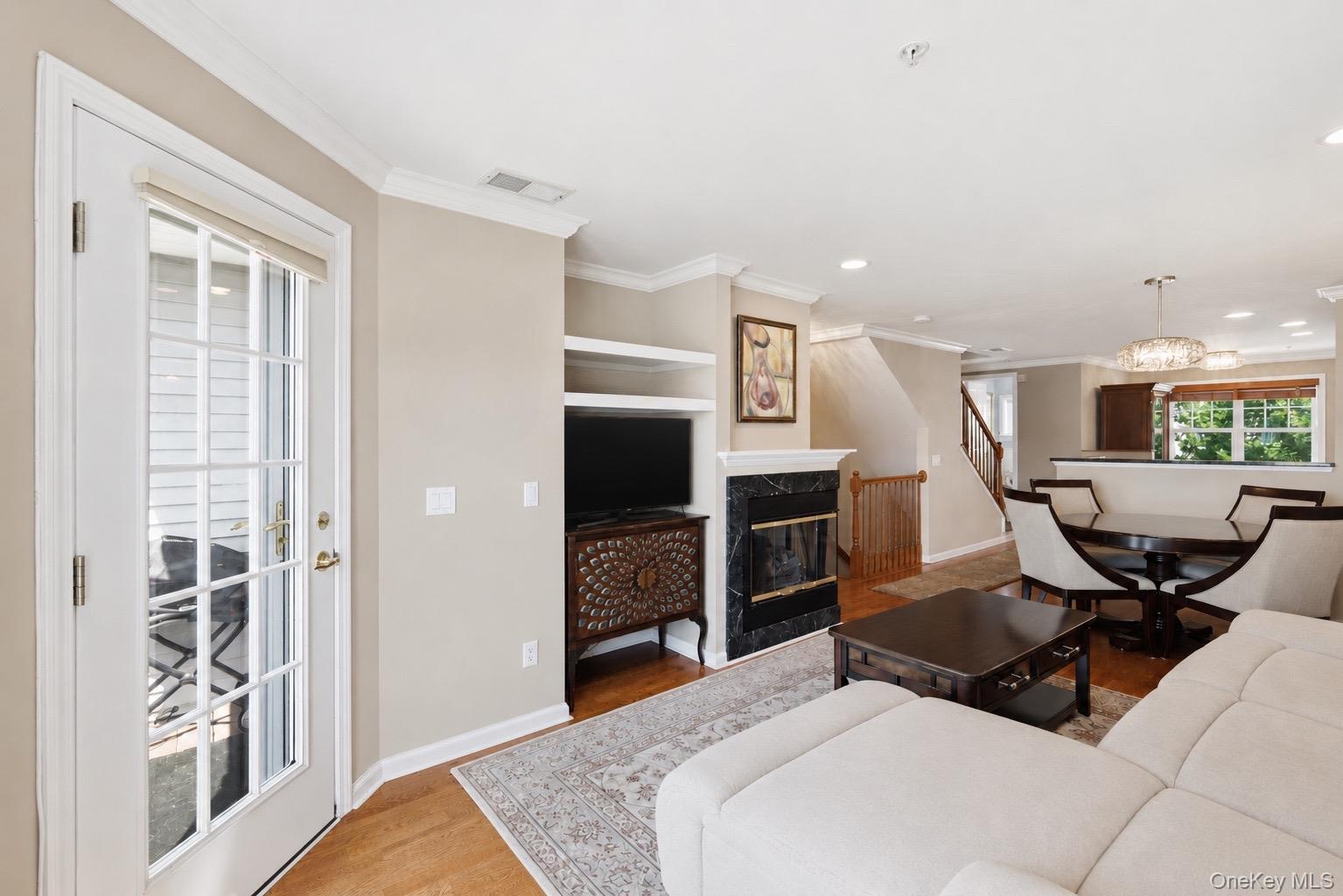 323 Waterside Close Peekskill, NY 10566 - Photo 9 of 42 Living area featuring wood flooring, a gas fireplace, and new built-in shelving