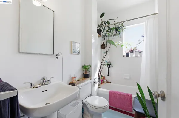 a bathroom with a sink a toilet and a mirror