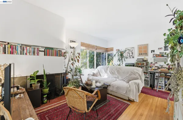 a living room with furniture and a book shelf