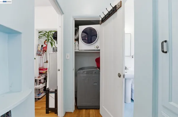 a view of a hallway with wooden floor and entryway