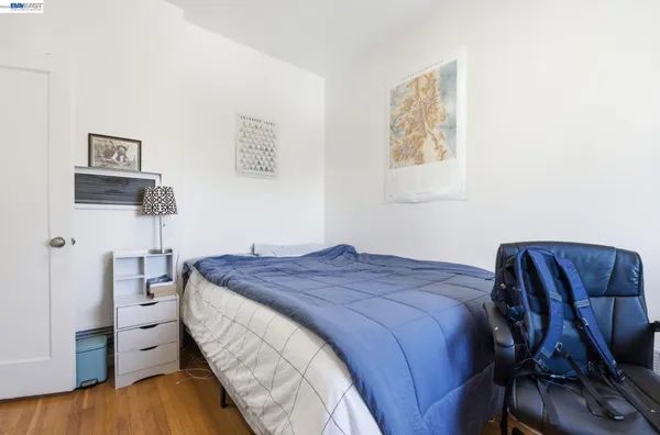 a bed room with a bed and a chair